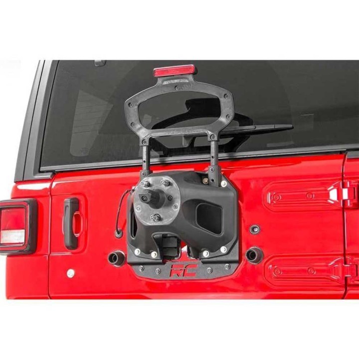 Rear relocation spare wheel carriers for vehicles with