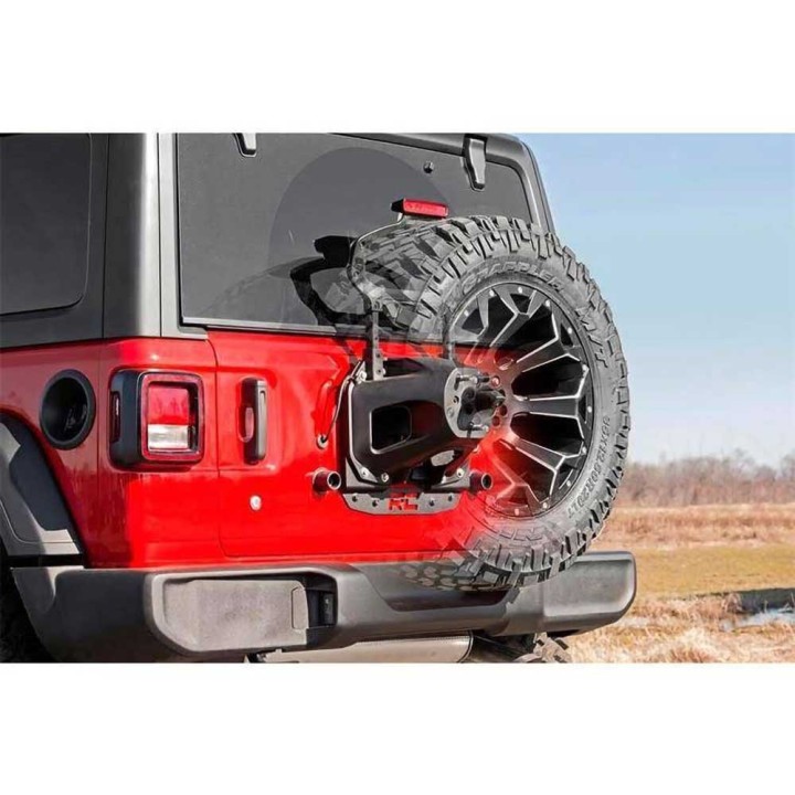 Rear relocation spare wheel carriers for vehicles with