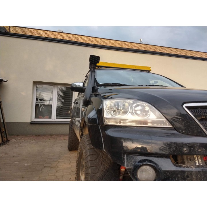 The snorkel along the Kia Sorento A-pillar: black tube with a mesh ram head